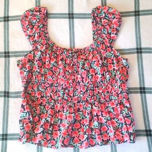 Cap sleeves. Tie front neck-line. Smoked bodice. Floral print.